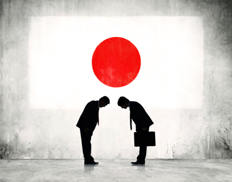 Two Japanese Business Person Greeting with Japanese Flag